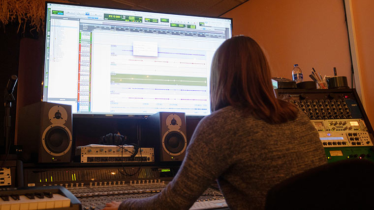 Student in recording studio.