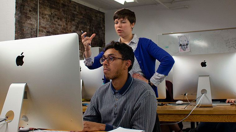 Art professor instructing student.