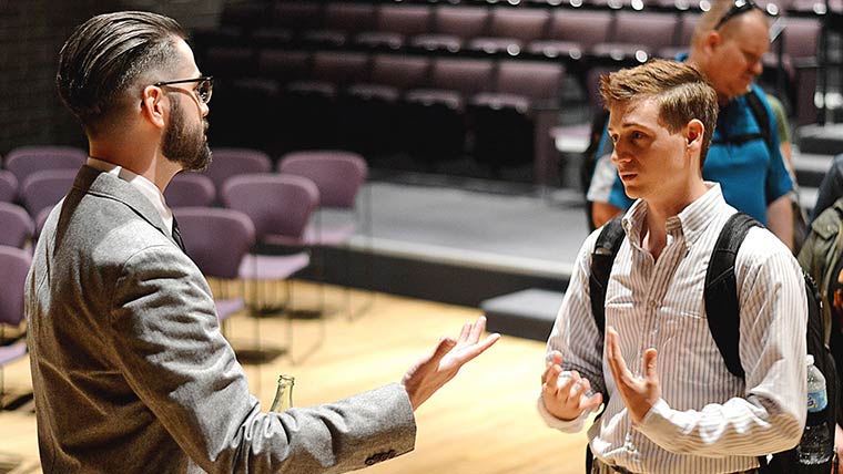 Student talking to professor.